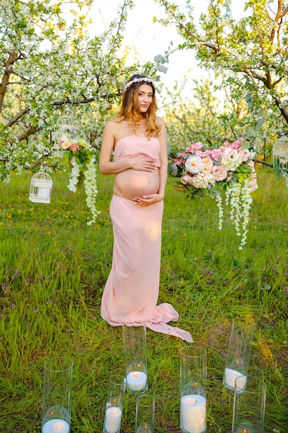 Enjoying healthy pregnancy smiling pregnant woman in rural landscape