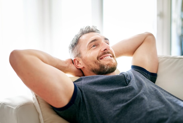 Enjoying his day off Shot of a handsome mature man relaxing on the sofa at home