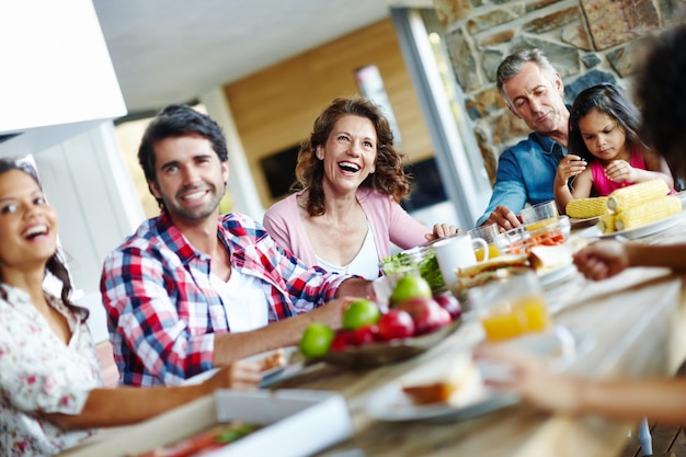 Enjoying mealtimes as a family A happy family enjoying a meal time together