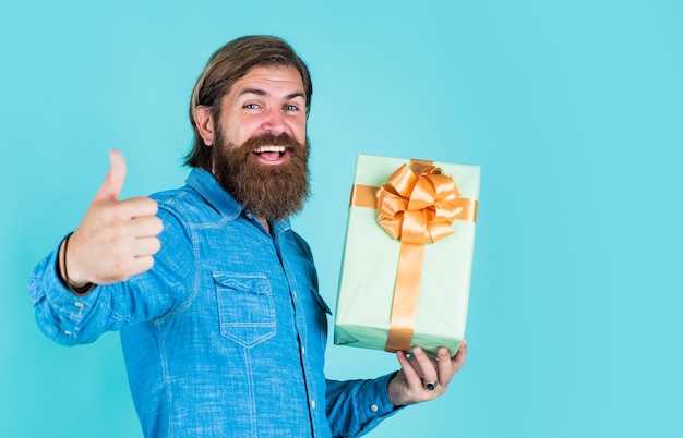 Enjoying online shopping commonly used for birthday buy anniversary gifts surprised male open box with something exciting inside mature man looking casual in surprise with present gift box