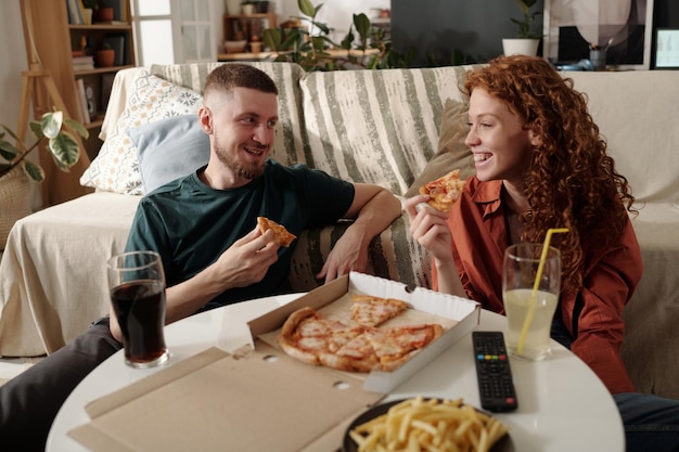Enjoying takeout pizza during discussion