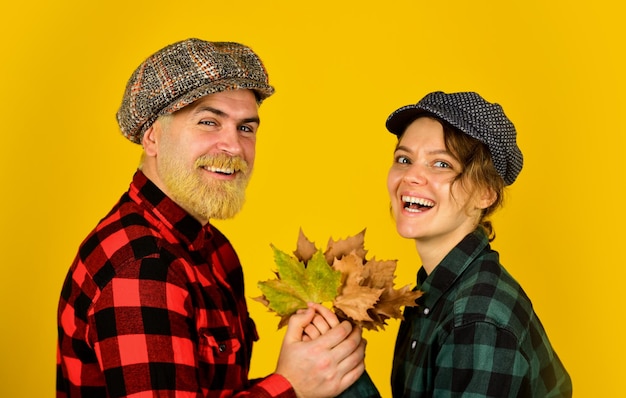 Enjoying time together harvest with farmers happy thanksgiving day retro couple autumn leaves man and woman hold maple leaf farmer in countryside collect fallen leaves fall seasonal concept