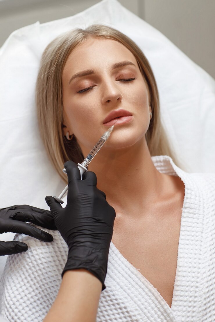Photo enlarging, correction lip. portrait white woman during an operation filling face wrinkles. plastic surgery. young woman getting cosmetic injection