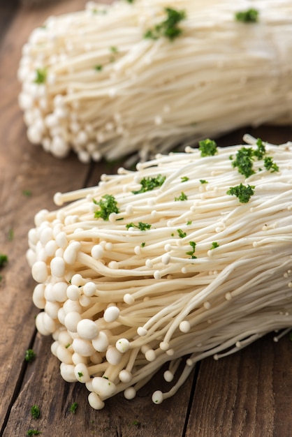 Enoki mushrooms on wood