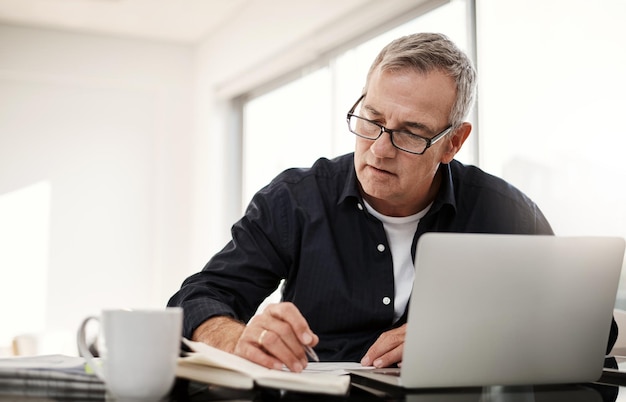 Ensuring his calculations stay spot on Shot of a mature man going through some paperwork at home