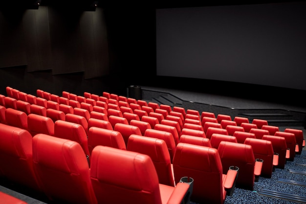 Entertainment and leisure concept - movie theater or cinema\
empty auditorium with red seats