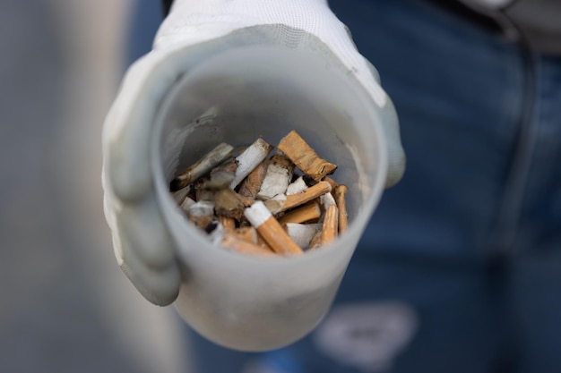 Enthusiast shows a glass of dropped cigarette bulls