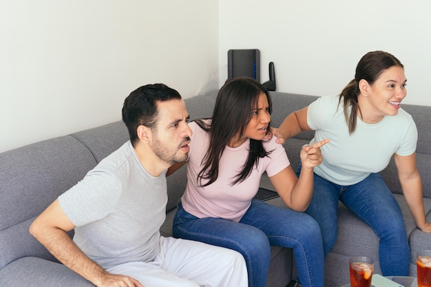 Enthusiastic sports enthusiasts watching television together