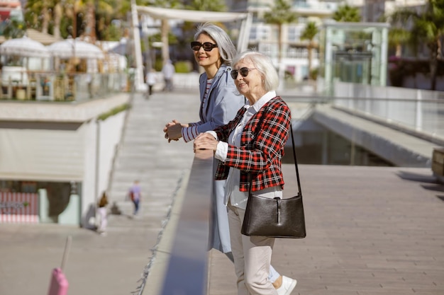 Enthusiastic women spending time together in city