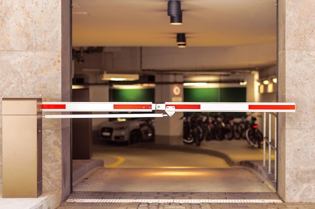 Entrance gate to underground garage parking car parking inside\
automatic barrier in car park