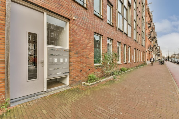 Entrance to a multistorey residential building with a metal door and an intercom