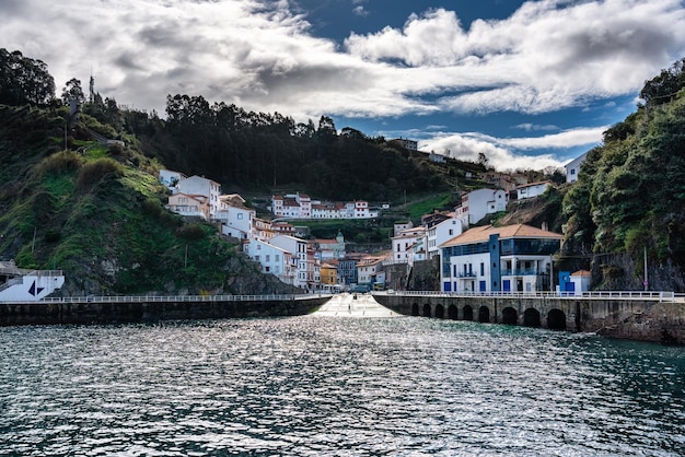 Entrance to the picturesque village of Cudillero with its houses hanging from the ravine by the sea Asturias Spain