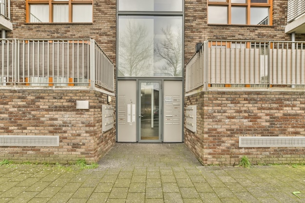 Entrance to a residential building built of light and dark brick with an intercom