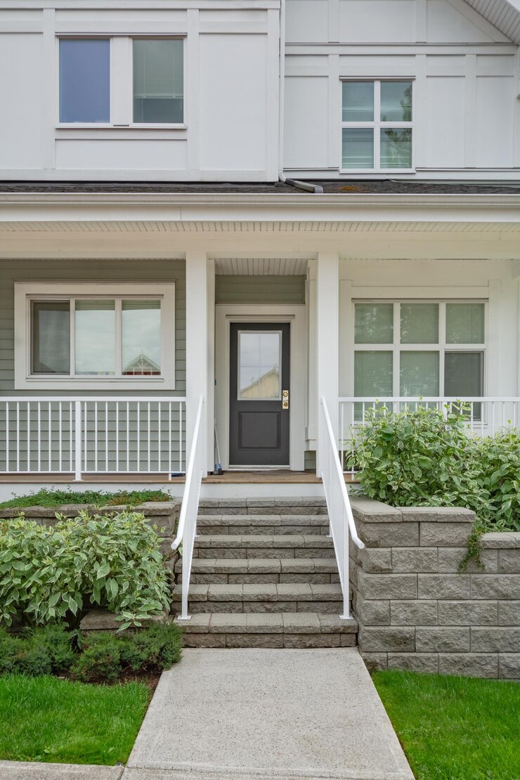 Entrance of residential unit under the porch with doorsteps in front