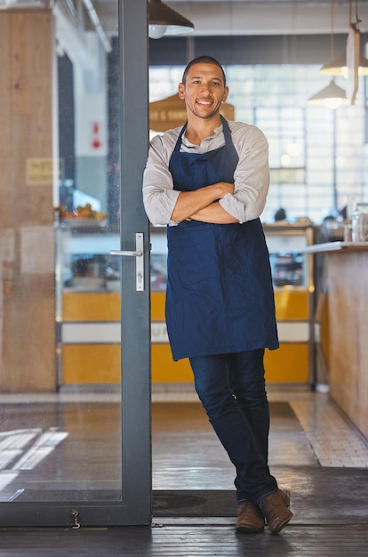 Entrepreneur of cafe or coffee shop small business and male owner of a modern startup restaurant Businessman with motivation manager and leadership skills standing at the door to welcome customers