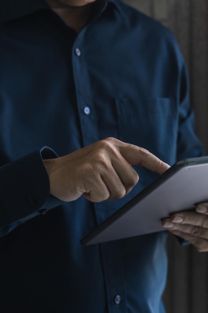 Entrepreneur checking daily work plan and email in tablet business man checking stock investment