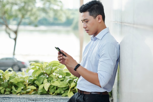 Entrepreneur checking notifications on phone