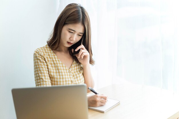 Entrepreneur concept a young businesswoman having conversation on a smart phone consulting on a business topic.