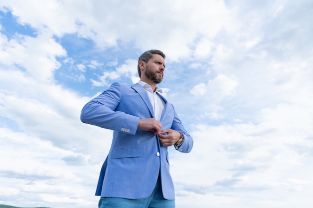 Entrepreneur or manager. male formal fashion. professional unshaven ceo. man bride groom on sky background. adult businessman in formalwear. business success. successful boss in businesslike suit.