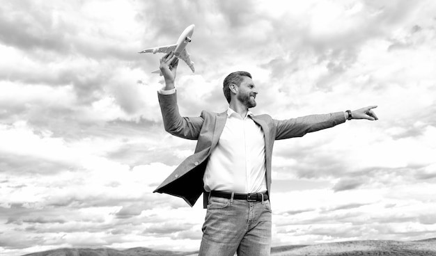 Entrepreneur ready for trip freedom mature boss with plane on sky background