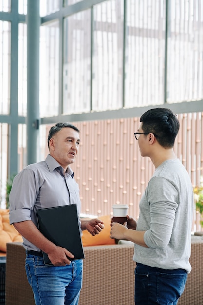 Entrepreneur talking to young employee