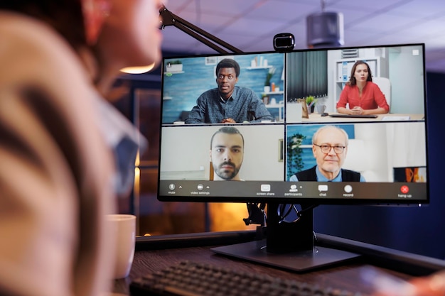 entrepreneur woman discussing marketing statistics with remote coworkers during online videocall meeting conference. business team working late at night at company financial to increase profit