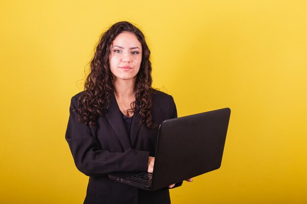 Entrepreneurial woman wearing suit holding laptop Business woman tele work