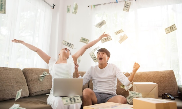 Entrepreneurs throwing paper currency in home
