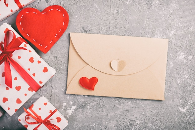 envelope and beautiful wrapped presents with ribbon