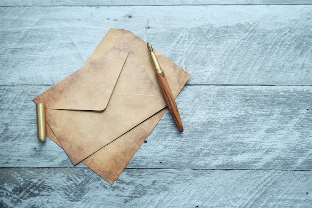 Envelope empty paper and fountain pen on table