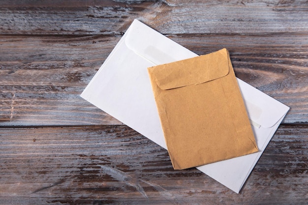 Photo envelope and envelope on wooden background