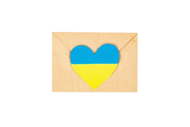 Envelope and heart in the colors of the Ukrainian flag Stop the war concept isolated on white background Flat lay a place for text mockup template top view