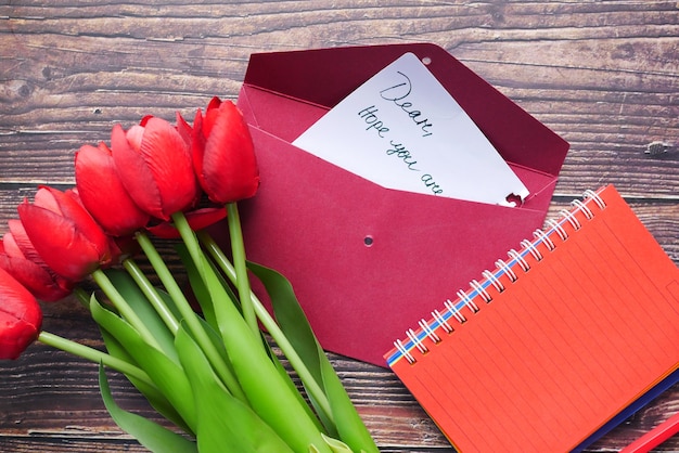 Envelope  letter and tulip flower on table