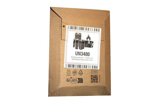 An envelope with a danger label contains a lithium battery that can catch fire The label has the UN3480 code for flammable lithium batteries The envelope is closed and prepared for shipping