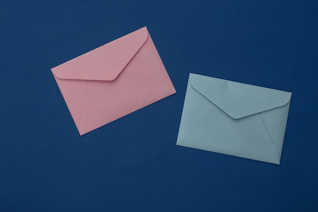 Envelopes on classic blue background. Color 2020. Top view