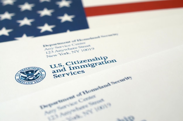 Buste con lettera dell'uscis sulla bandiera degli stati uniti del dipartimento della sicurezza interna