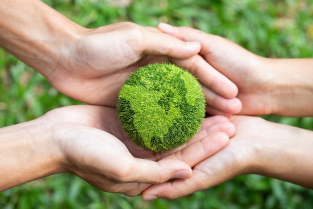 Photo environment earth day two hands holding together a green earth