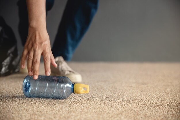 environment ecology care renewable concept volunteer collecting plastic bottle waste on floor