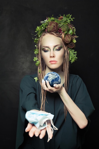 Environment protection concept Woman during COVID19 holding Earth this image furnished by NASA