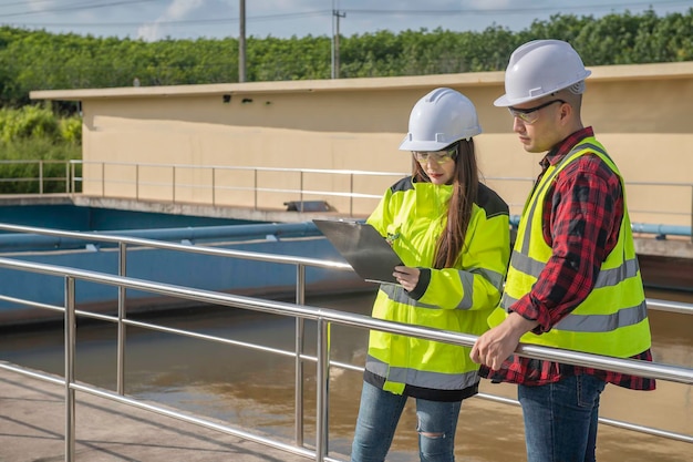 Environmental engineers work at wastewater treatment
plantswater supply engineering working at water recycling plant for
reusetechnicians and engineers discuss work together