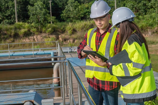 Environmental engineers work at wastewater treatment\
plantswater supply engineering working at water recycling plant for\
reusetechnicians and engineers discuss work together