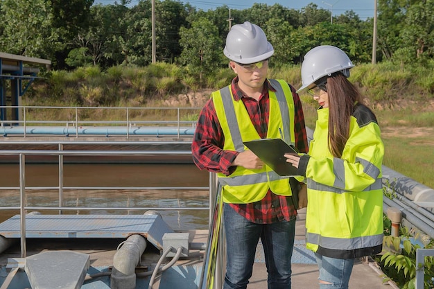 Environmental engineers work at wastewater treatment plantsWater supply engineering working at Water recycling plant for reuseTechnicians and engineers discuss work together