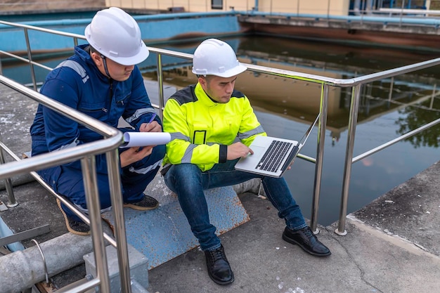 Environmental engineers work at wastewater treatment plantsWater supply engineering working at Water recycling plant for reuseTechnicians and engineers discuss work together