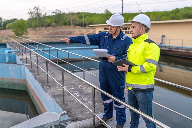 Environmental engineers work at wastewater treatment plantsWater supply engineering working at Water recycling plant for reuseTechnicians and engineers discuss work together