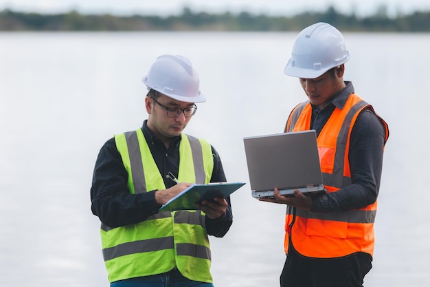 Environmental engineers work at wastewater treatment plantsWater supply engineering working at Water recycling plant for reuseTechnicians and engineers discuss work together