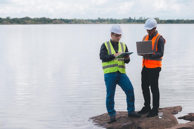 Environmental engineers work at wastewater treatment
plantswater supply engineering working at water recycling plant for
reusetechnicians and engineers discuss work together