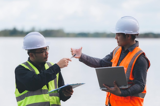 Environmental engineers work at wastewater treatment
plantswater supply engineering working at water recycling plant for
reusetechnicians and engineers discuss work together