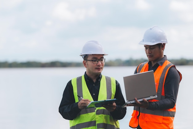 Environmental engineers work at wastewater treatment
plantswater supply engineering working at water recycling plant for
reusetechnicians and engineers discuss work together