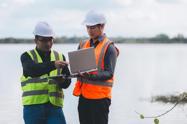 Environmental engineers work at wastewater treatment
plantswater supply engineering working at water recycling plant for
reusetechnicians and engineers discuss work together