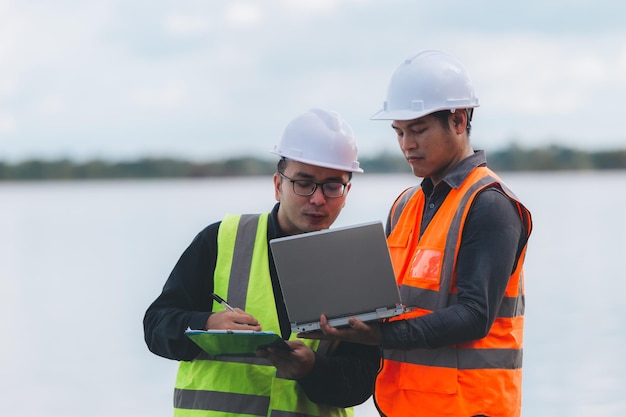 Environmental engineers work at wastewater treatment plantsWater supply engineering working at Water recycling plant for reuseTechnicians and engineers discuss work together